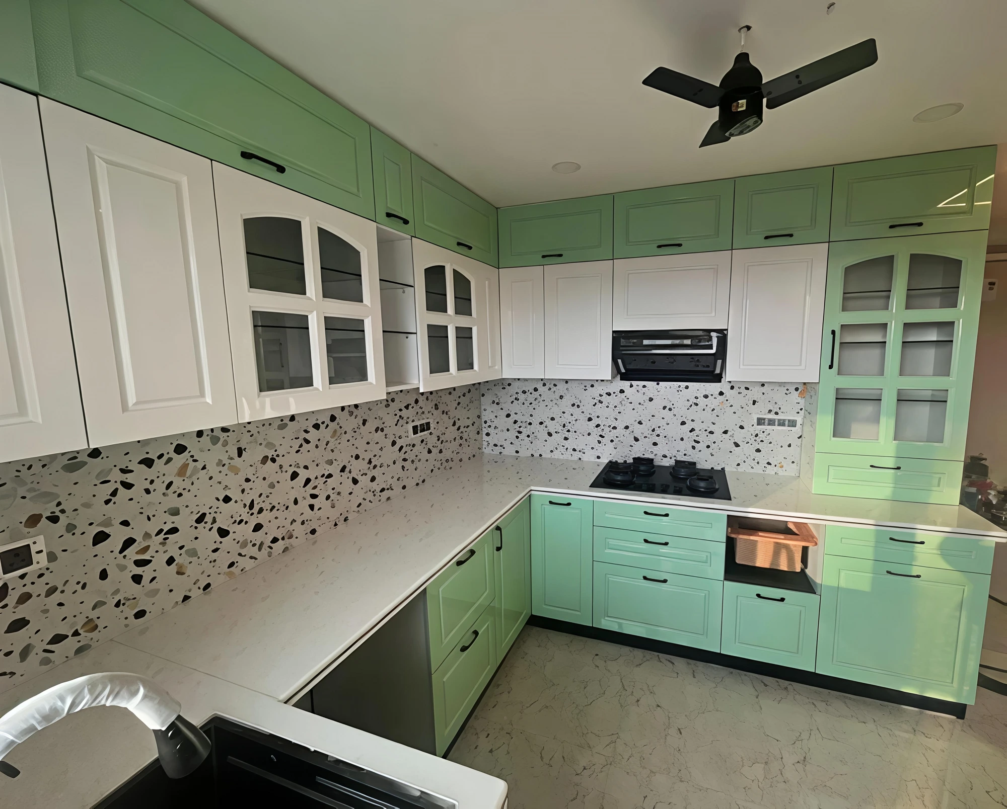 Mint and white modular kitchen with terrazzo backsplash