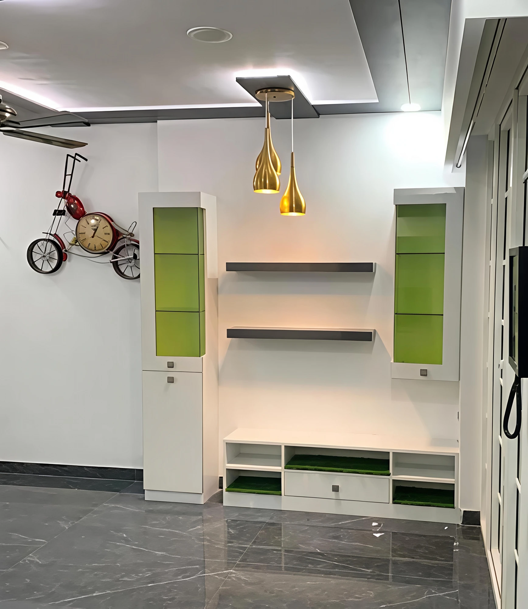 Green and white TV console with gold pendant lights